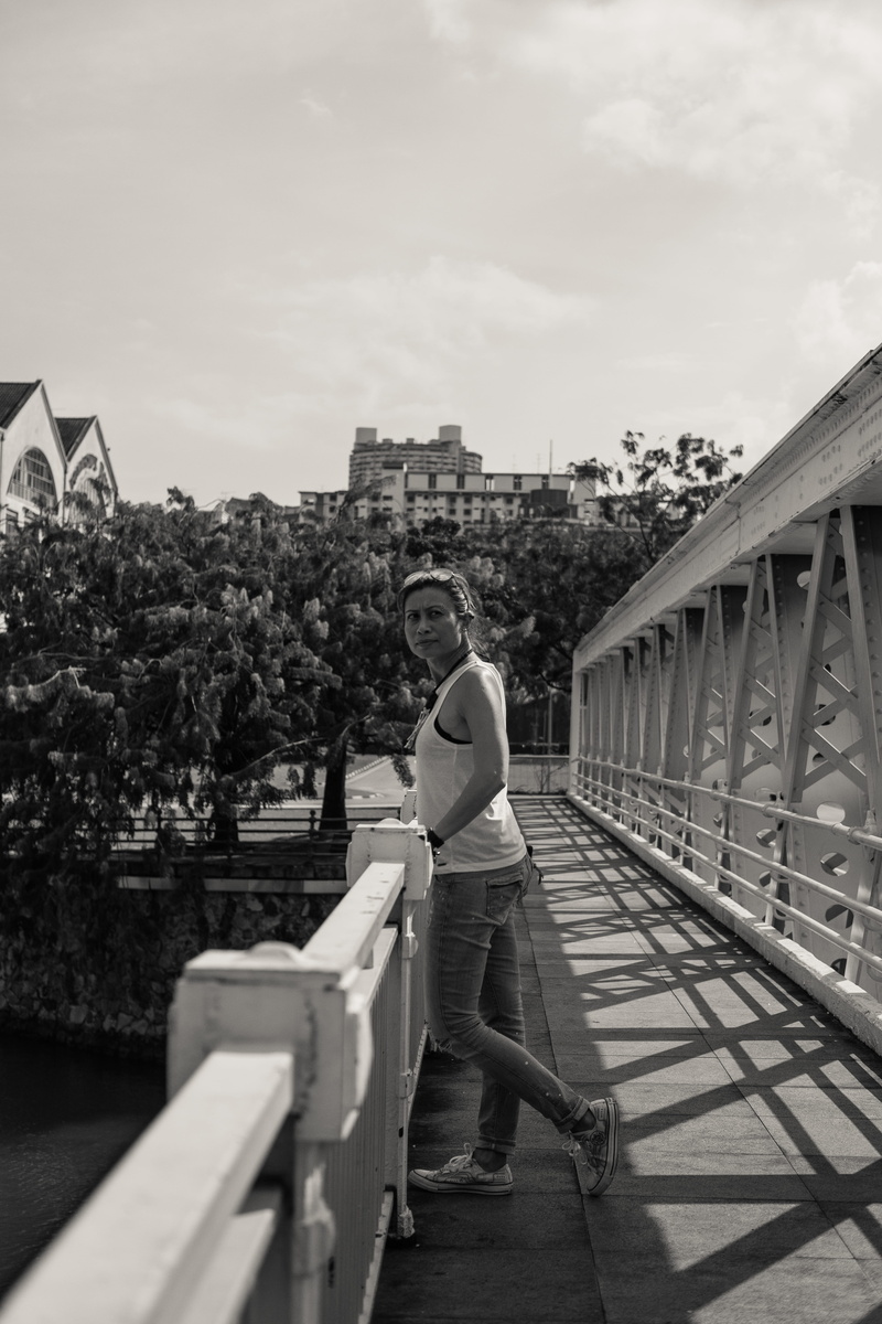 shorts, person, built structure, tough, standing, shoe, bridge - man made structure, trees, clothing, footwear, 5K, building exterior, banister, leisure activity