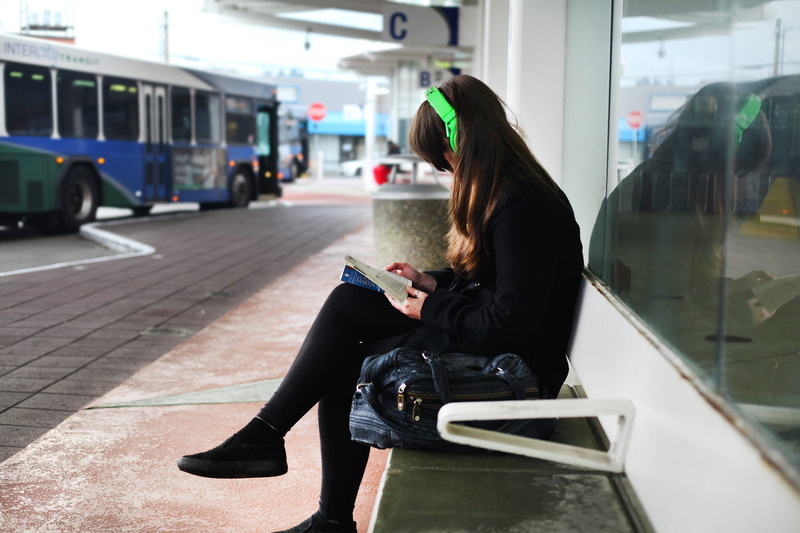women, person, holding, book, connection, solo, casual clothing, portable information device, rail transportation, waiting, mode of transportation, lifestyles