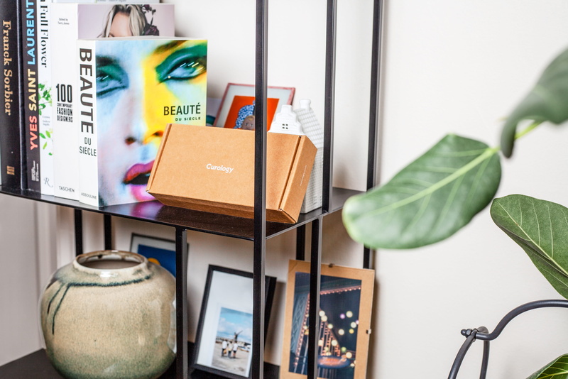 day, furniture, publication, box, person, plant, book, living room, selective focus, package delivery, keyboard, electric lamp, potted plant, close-up