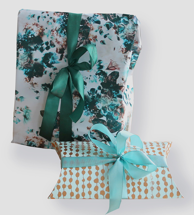 floral pattern, bow, tape, green, box - container, surprise, indoors, christmas, white, wrapping, surprises, no people, fashion, white background, rectangular