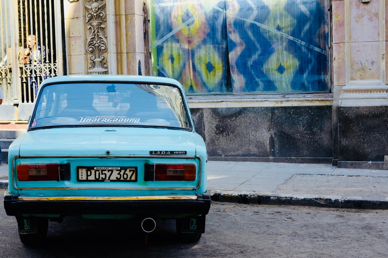 sports car, road, street, building, automobile, cuba, land vehicle, lada, teal, public transportation, street art, parked, motor vehicle, outdoors, vintage