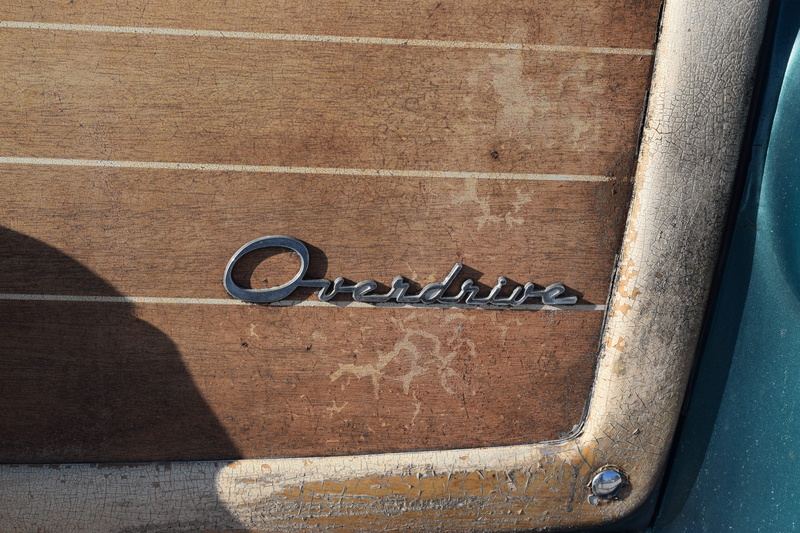 emblem, tabletop, silver, wall, weapon, wall - building feature, western script, trademark, communication, high angle view, brown, blade, logo, wooden