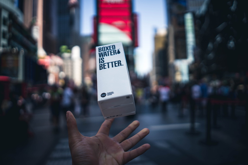 focus on foreground, day, communication, newyork, human finger, product, throw, throwing, box, person, boxedwater, finger, boxes, human hand, white, 5K