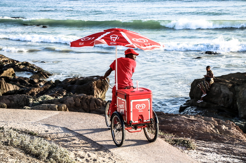 rock, selling, red, products, water, ice cream, near, rock - object, male, sea, solid, ocean, cart, boy, adult, real people, people, 5K, beach, man, umbrella