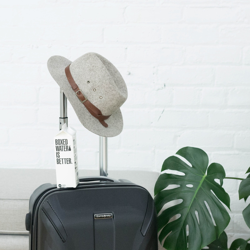 green color, boxed, hat, personal accessory, travel, still life, absence, wall - building feature, sit, carton, suitcase, 2K, clothing, text, no people
