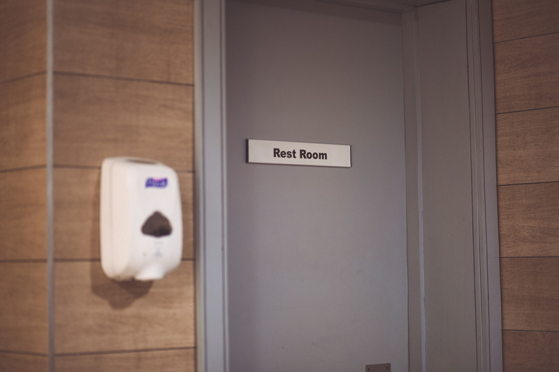 push button, wall - building feature, communication, public building, domestic room, soap dispenser, wood - material, focus, sanitizer dispenser, text