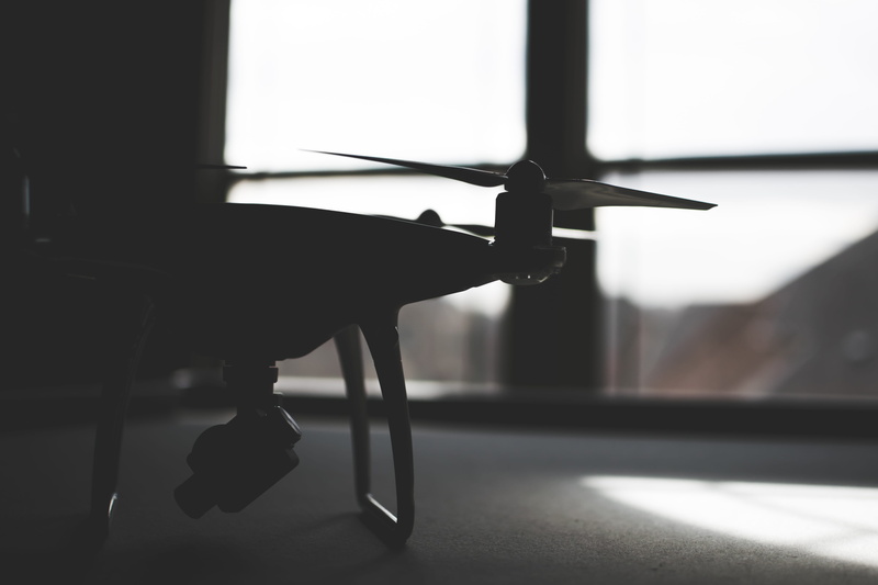 seat, day, single object, dji, indoors, air vehicle, transparent, close-up, focus on foreground, phantom 4, flooring, still life, glass - material, absence