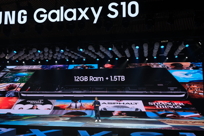 information sign, illuminated, western script, city, smartphone, person, automobile, technology, screen, business, monitor, stage, travel, black, commercial sign