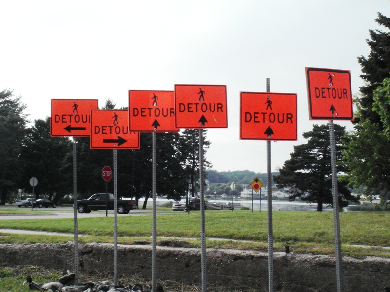 2K, s, script, arrows, sign, text, no people, outdoors, information, conflict, sky, nature, green, land, chaos, road, western script, information sign