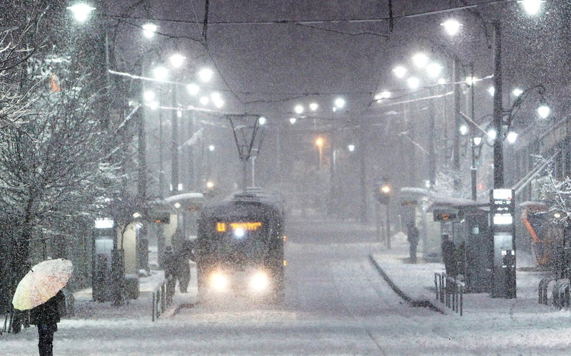 people, winter, trees, wires, 1080P, snow, houses, city, stop, snowfall, lights, tram