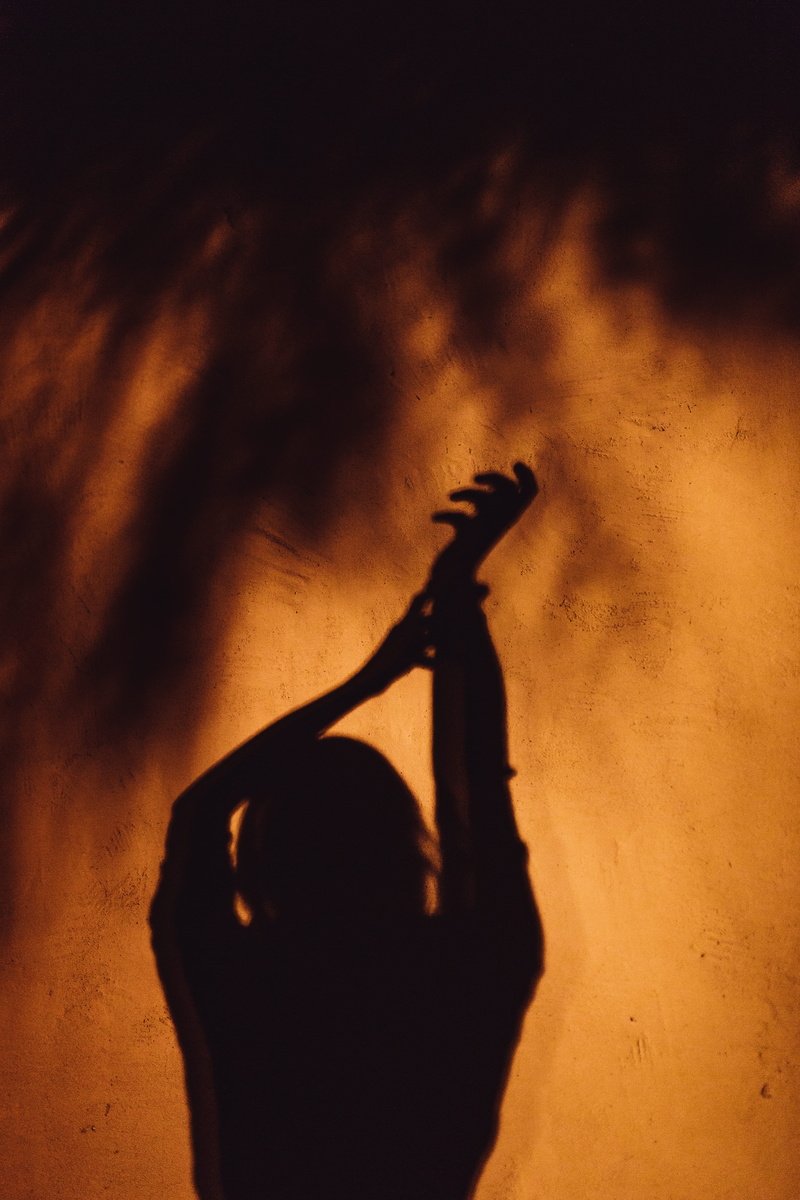 human arm, focus on shadow, silhouette, stretching, orange, spooky, emotion, hand, limb, burnt orange, body part, shadow, wall surface, raising, dark, shadow on wall