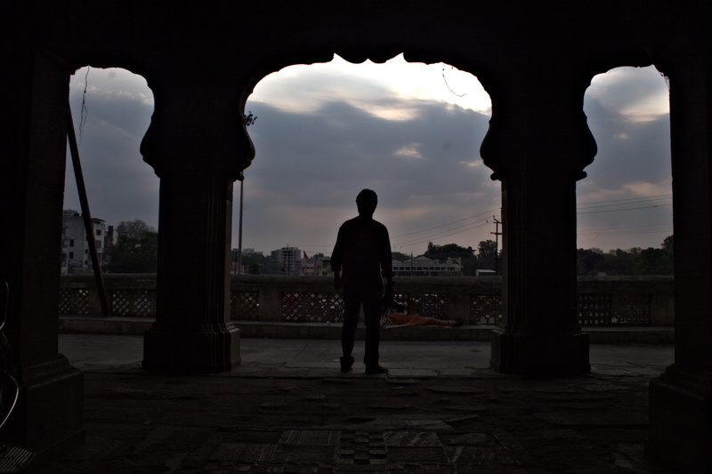 outdoors, famous Place, one person, rear view, city, architecture And Buildings, monument, leisure activity, architectural Column, sky, Evening, cloud - sky