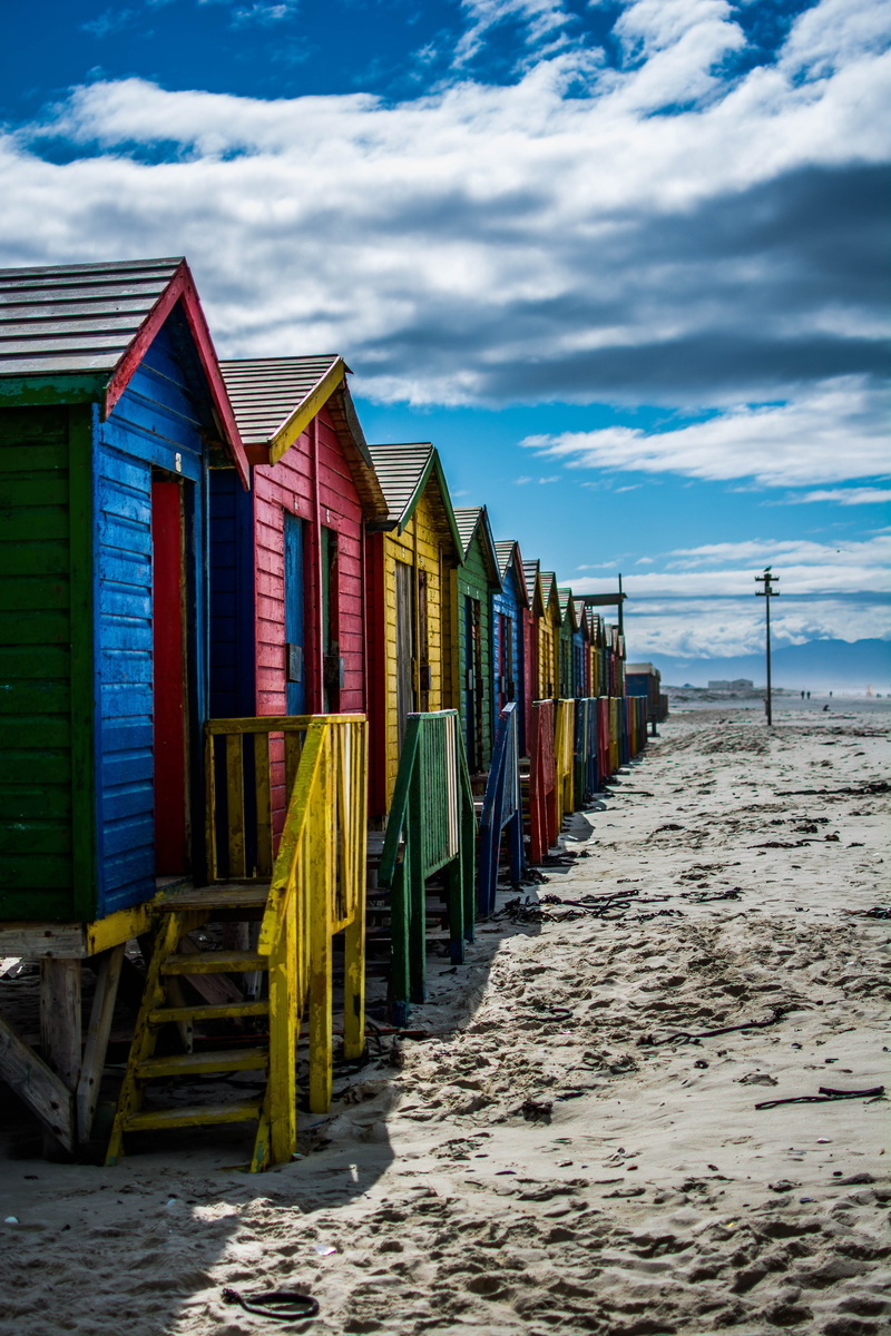 cloud - sky, wood - material, wooden post, sand beach, africa, hut, sea, built structure, cottage, land, muizenberg, side by side, water, multi colored