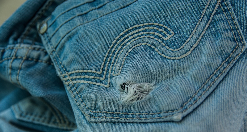 human leg, casual clothing, material, midsection, body part, lifestyles, fashion, pocket, hole, worn, old, textile, one person, indoors, pants, denim, textured