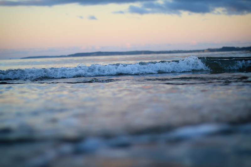 sky, beauty in nature, motion, beach, rushing, surface level, aquatic sport, wave, selective focus, hatfields beach, flowing water, outdoors, day, hatfield bay reserve