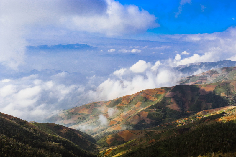rolling landscape, outdoors, mountain range, tranquility, idyllic, no people, mountain, scenics, cloud - sky, view from above, land, non-urban scene, nature