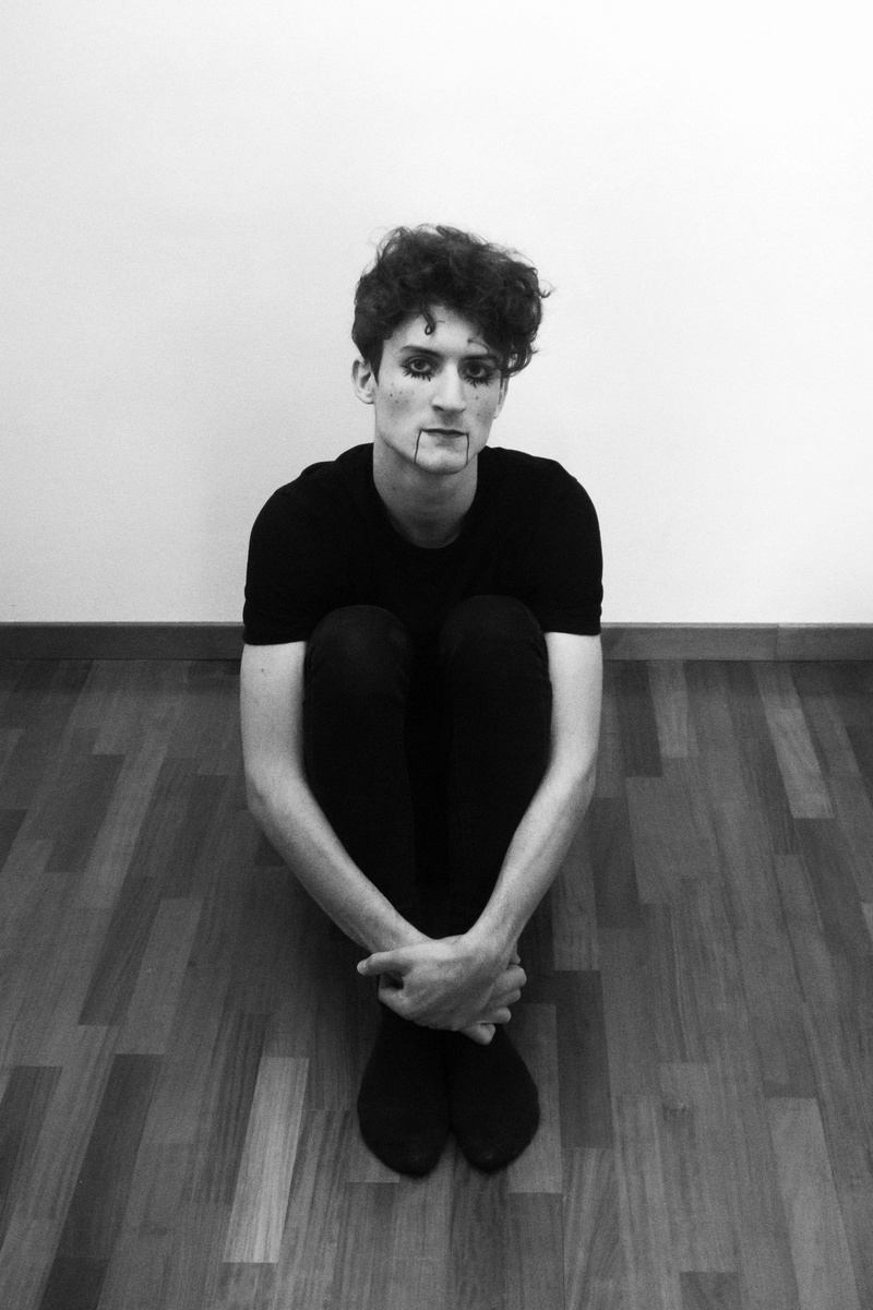 young adult, facial expression, wear, flooring, wood, black, portrait, lifestyles, indoors, adult, pose, grayscale, photo, person, studio, floor, model