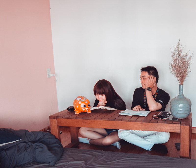 table, adult, wall - building feature, coffee table, indoors, couple, sitting, coffee, boy, woman, wear, brown, love, man, sit, girl, inside, bed, home interior