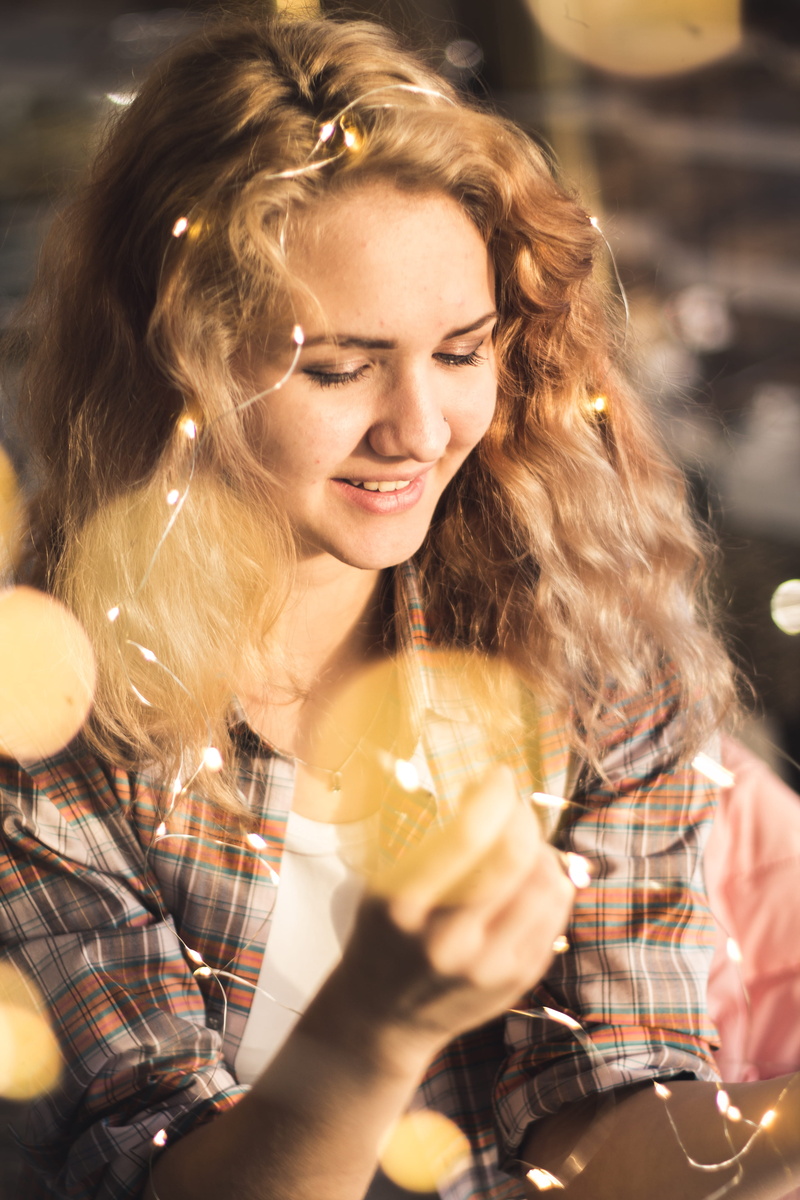 real people, food and drink, blond hair, women, lights, fairy, leisure activity, beautiful woman, portrait, smiling, red hair, russia, hair, alcohol, christmas lights