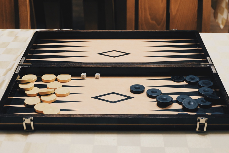 strategy, still life, chess piece, entertainment, game, table, indoors, activity, black color, competition, chess, board game, high angle view, backgammon