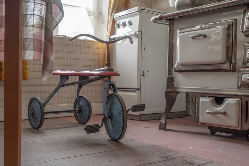 wheel, bike, decorative, trike, door, nostalgia, range, day, indoors, domestic room, mode of transportation, land vehicle, transportation, black, no people