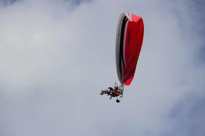 unrecognizable person, extreme Sports, joy, sky, flying, red, people, fun, parachute, air sports, parachuting, motion, exhilaration, air Vehicle, sport