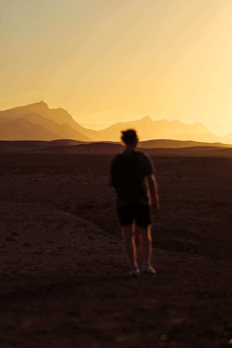 hour, orange color, desert, cliff, tranquility, tranquil scene, silhouette, walking, real people, land, arid climate, mountain, nature, leisure activity