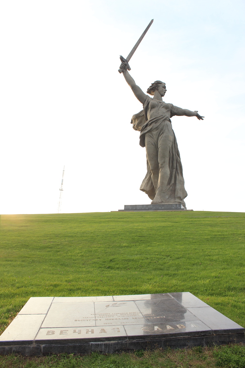 male likeness, grass, sky, arms raised, statue, human arm, clear sky, Mother Motherland, field, history, adult, sculpture, outdoors, travel, land, Volgograd