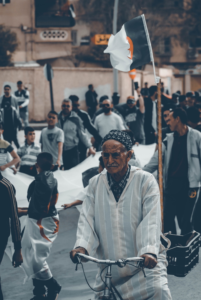 religion, people, glasses, street, lifestyles, casual clothing, group together, sitting, leader, architecture, ceremony, incidental people, transportation