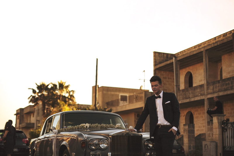 classic car, tuxedo, beside, sky, architecture, groom, silver, man in black, land vehicle, one person, outdoors, car, well-dressed, grey classic, near