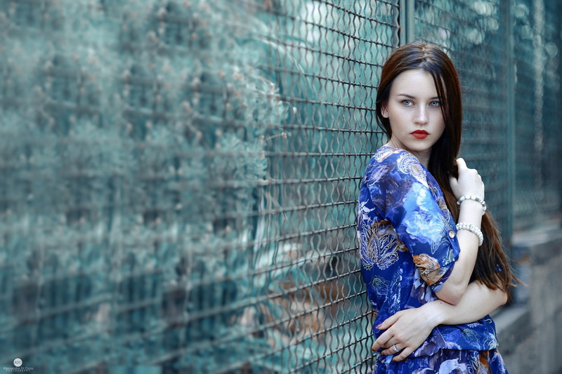 standing, beauty, blue eyes, contemplation, long hair, one person, adult, dress, bracelets, women, three quarter length, fence, red lipstick, beautiful woman