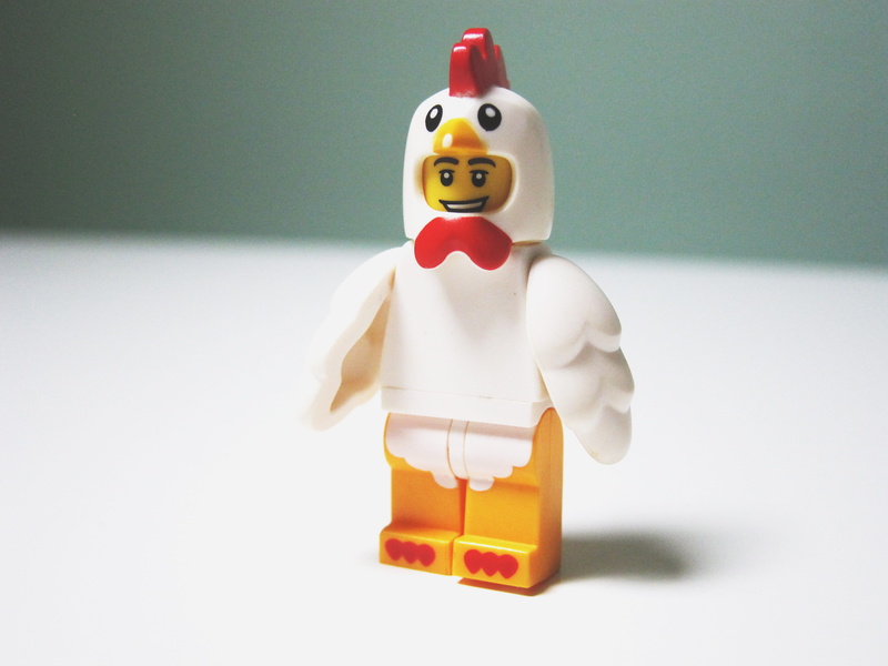 indoors, male likeness, figure, figurine, 2K, studio shot, chicken suit, table, humor, creativity, shallow, chicken, lego, no people, human representation