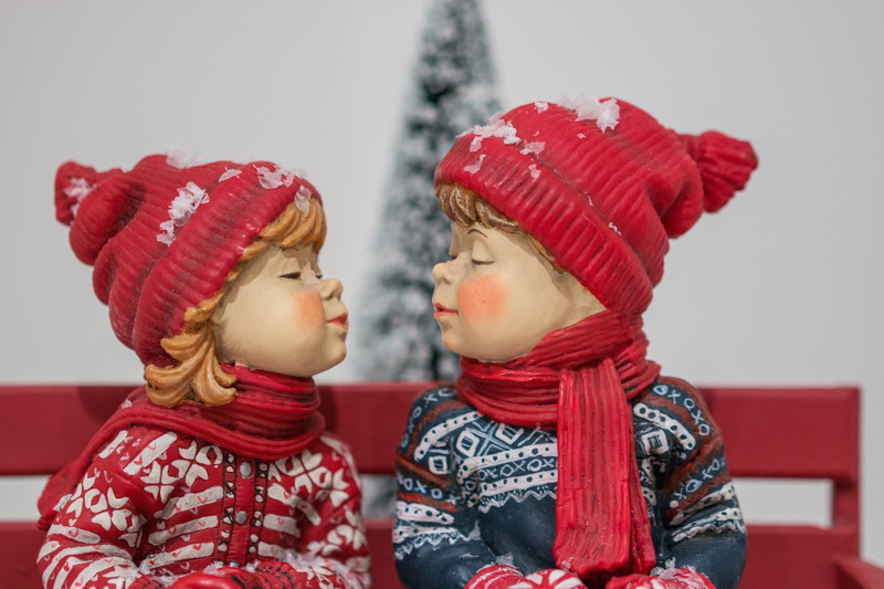 side view, snowy, ball, snow, cold temperature, poinsettia, females, family, warm clothing, kiss, made, dolls, women, scarf, childhood, hinder, figurine