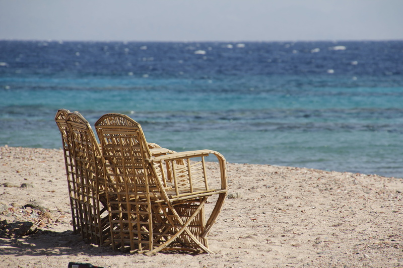 scenics - nature, by the sea, tranquility, beach, summer, water, land, no people, sit, horizon over water, abandoned, sky, seating furniture, vacations