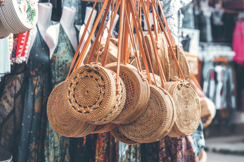 retail display, 5K, hat, hanging, bag, day, market stall, incidental people, focus on foreground, market, variation, large group of objects, basket, round