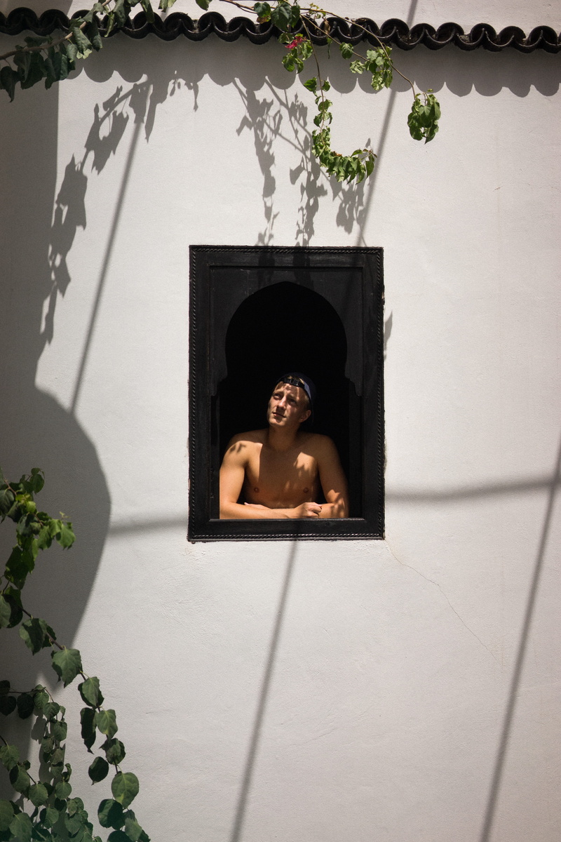 one person, indoors, lifestyles, leisure activity, tree, hole, window, clothing, day, morrocco, architecture, person, brick, back, human, advertisement