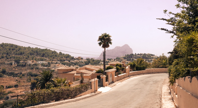 road, the way forward, spain, houses, tree, built structure, trees, sky, mountain, no people, tranquility, outdoors, direction, nature, building exterior