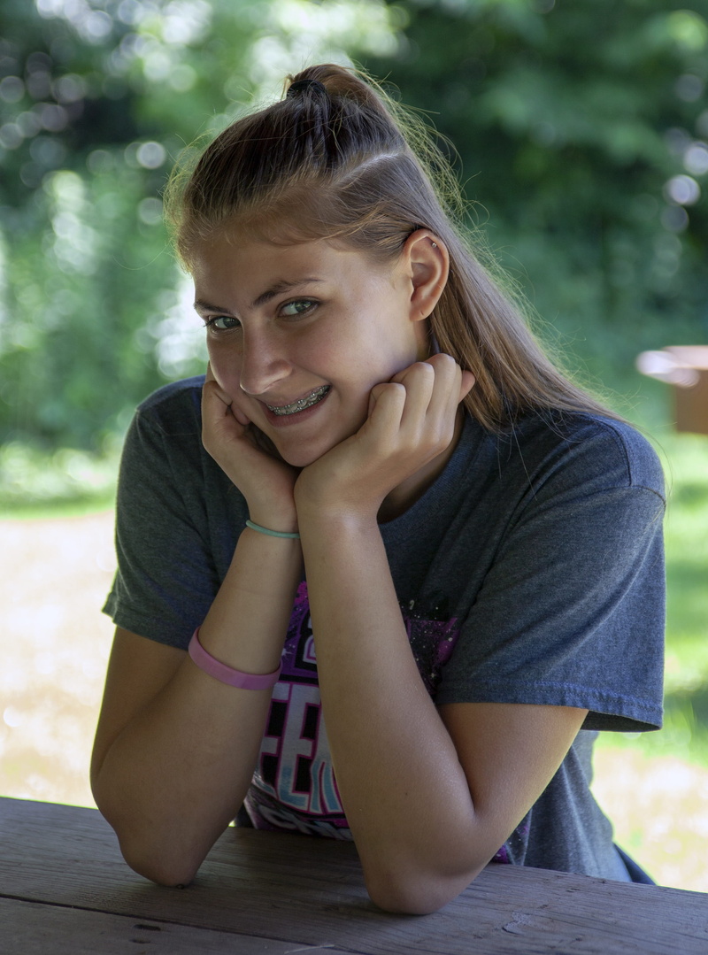 hairstyle, emotion, front view, childhood, portrait, looking at camera, smile, braces, innocence, model, outdoors, day, lifestyles, one person, leisure activity