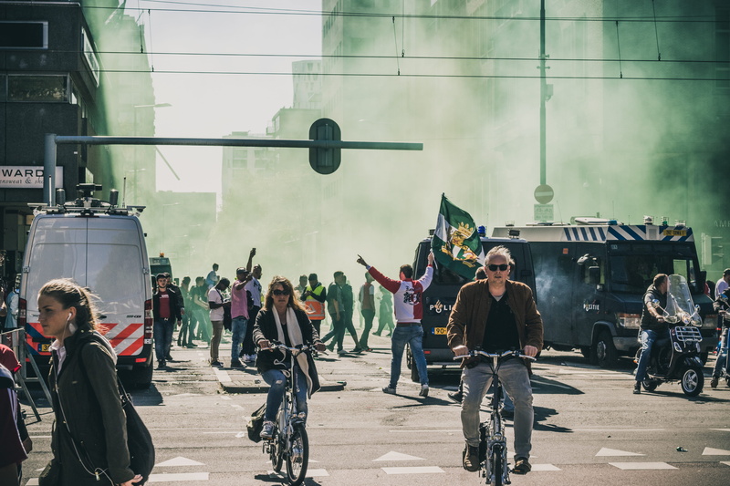 architecture, mode of transportation, people, built structure, crowd, city, street, stranded, land vehicle, lifestyles, daytime, adult, war, group of people