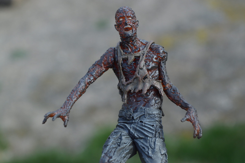 front view, monster, charred, evil, close-up, 5K, outdoors, burned, undead, nature, tv, horror, day, real people, human arm, creepy, focus on foreground
