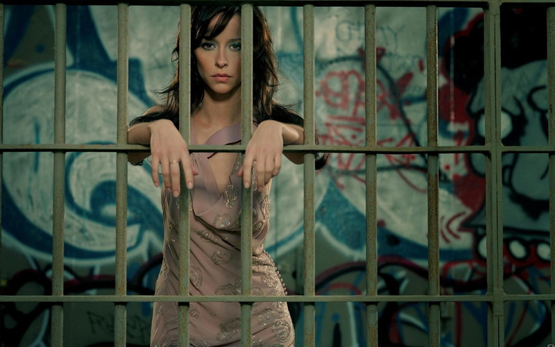 prisons, looking at camera, real people, standing, Jennifer Love Hewitt, contemplation, hairstyle, celebrity, beautiful woman, lifestyles, front view, graffiti