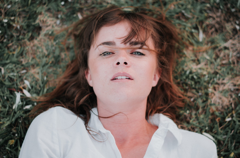 hair, innocence, contemplation, focus on foreground, nature, dyed red hair, one person, grass, girl, woman, girls, portrait, lying down, shirt, 5K, field