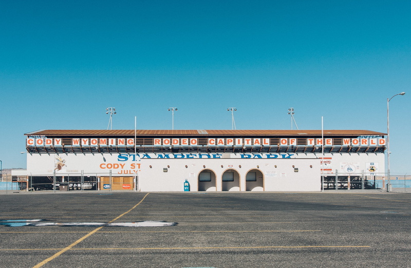 rode, sunny, passing, street, copy space, built structure, building exterior, blue, outdoors, road, sign, transportation, no people, wyoming, text, day