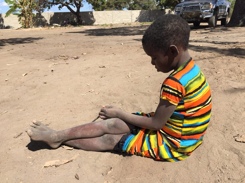 leisure activity, female, poverty, casual clothing, real people, land, nature, sunlight, men, outdoors, lonely, child, full length, sitting, poor, boy