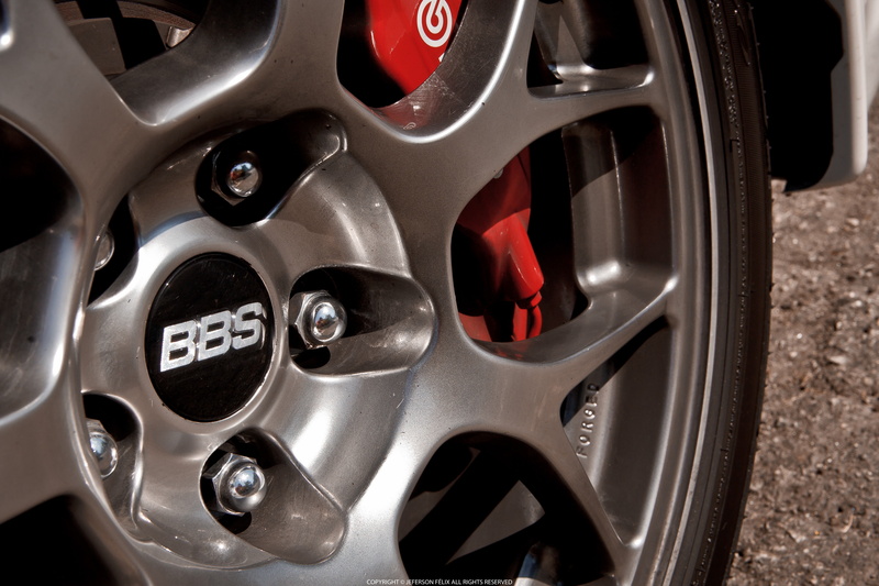 motor vehicle, no people, car, focus on foreground, sports car, silver colored, wheel, close-up, car interior, number, metal, luxury, land vehicle, day