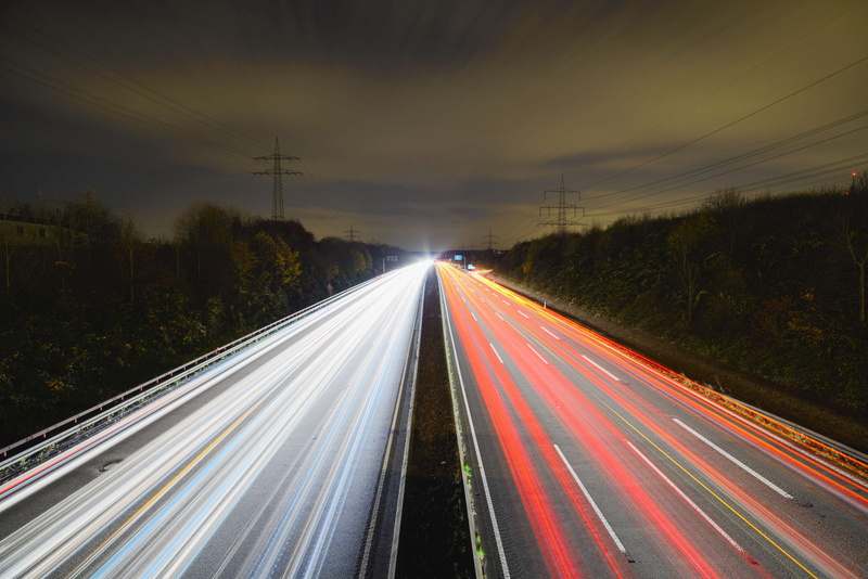no people, outdoors, highway, multiple lane highway, dusk, traffic, expressway, guidance, blurred motion, dark, night, high angle view, night photography