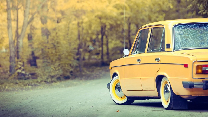 outdoors, tree, lada, motor vehicle, vehicle, vaz-2101, family car, sedan, nature, car, lada 1200, land, plant, zhiguli, focus on foreground, yellow, classic car