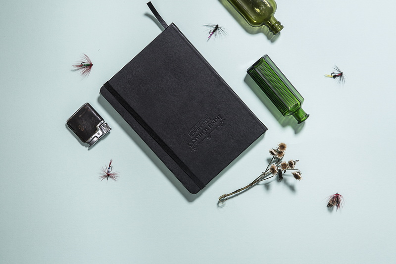 close-up, black, surface, indoors, green, notebook, no people, technology, bottle, vase, publication, view, items, high angle view, still life, white background