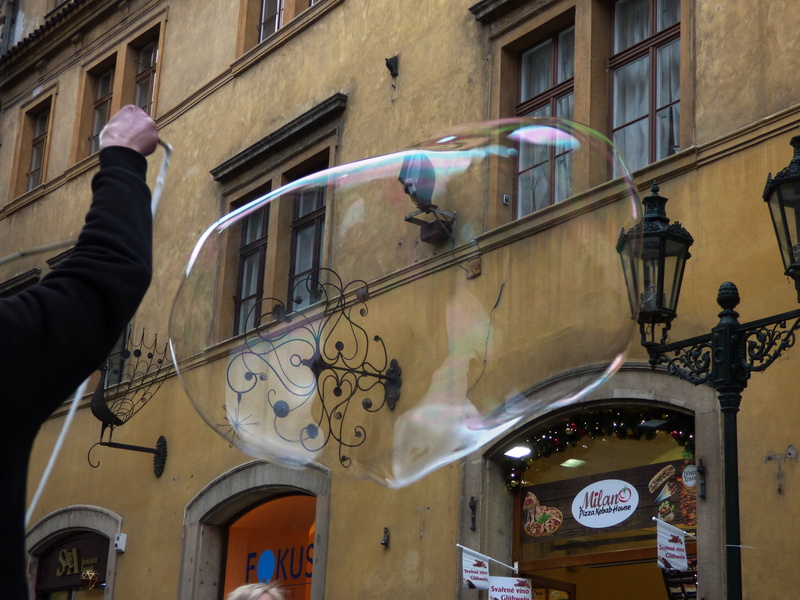 built structure, men, low angle view, reflection, soap bubbles, round, real people, air, the delicacy, colors, street, building, bubbles, reflex, let, outdoors