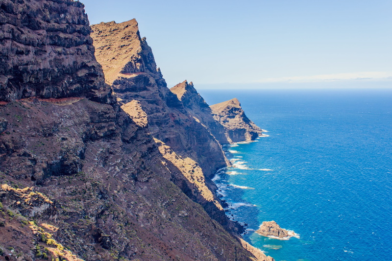 mountain, tranquil scene, mountains, rock - object, outdoors, eroded, beach, scenics, 2K, gran canaria, mountain range, travel, blue, lookout rocks, solid